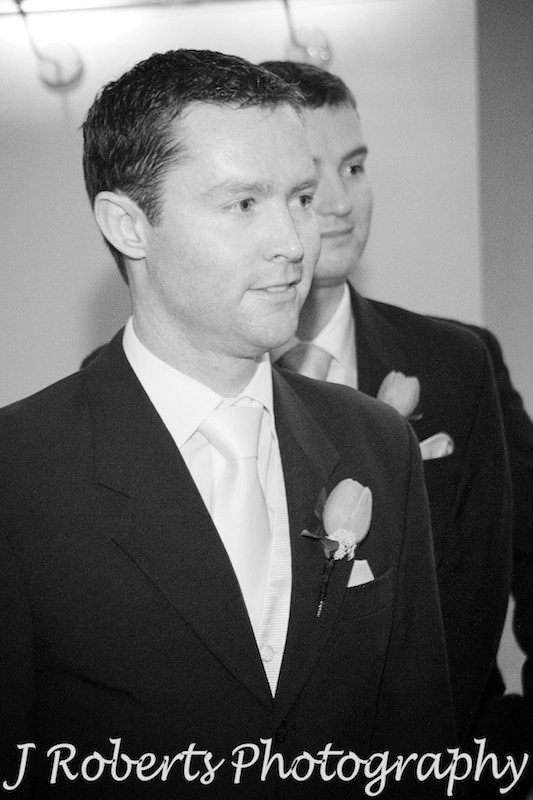 Groom smiling at bride coming down the aisle - wedding photography sydney